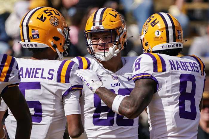 Oct 7, 2023; Columbia, Missouri, USA; LSU Tigers tight end Mason Taylor (86) celebrates with quarterback Jayden Daniels (5) and wide receiver Malik Nabers (8) after scoring against the Missouri Tigers during the first half at Faurot Field at Memorial Stadium. Mandatory Credit: Denny Medley-USA TODAY Sports